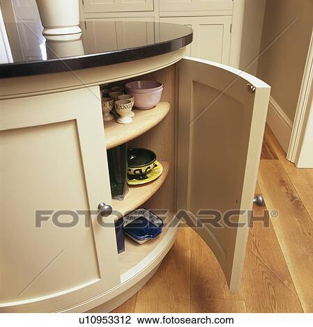 Close-up of pottery on shelves in built-in curved kitchen cupboard View Large Photo Image Stock Image - Close-up of pottery on shelves in built-in curved kitchen cupboard. Fotosearch