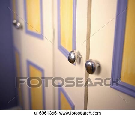 Close up of purple, yellow and white painted wardrobe doors with contemporary stainless steel knobs View Large Photo Image Stock Photograph - Close up of purple, yellow and white painted wardrobe doors with contemporary stainless steel knobs. Fotosearch