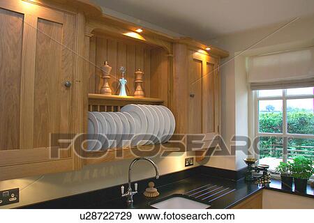 Close-up of recessed lighting and fitted plate rack above sink underset in granite worktop View Large Photo Image Stock Photo - Close-up of recessed lighting and fitted plate rack above sink underset in granite worktop. Fotosearch