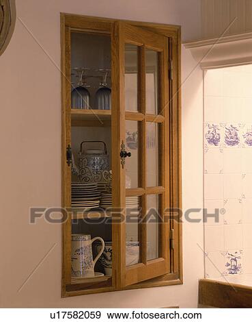 Stock Photo - Close-up of recessed wall cupboard with glazed door. Fotosearch