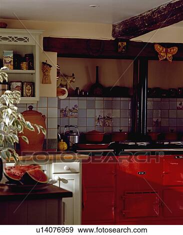 Stock Photo - Close-up of red Aga in cottage kitchen. Fotosearch