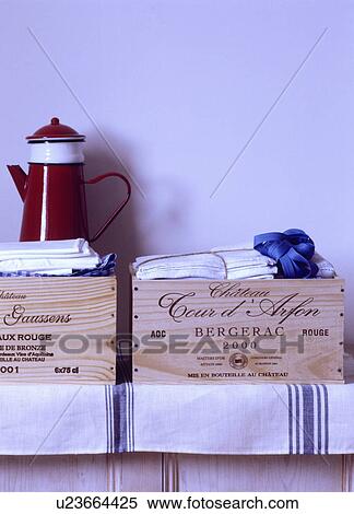 Stock Photography - Close-up of red enamel coffeepot on old wine boxes. Fotosearch