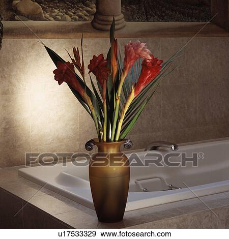Close-up of red flowers in bronze vase on the side of bath View Large Photo Image Stock Photo - Close-up of red flowers in bronze vase on the side of bath. Fotosearch