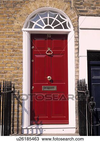 Stock Image - Close-up of red traditional front door. Fotosearch