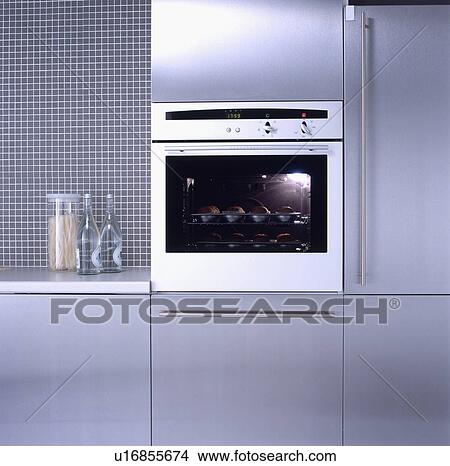 Picture - Close-up of stainless steel oven in fitted grey kitchen unit&#13; &#10; &#13; &#10; &#13; &#10; &#13; &#10; &#13; &#10; &#13; &#10;. Fotosearch