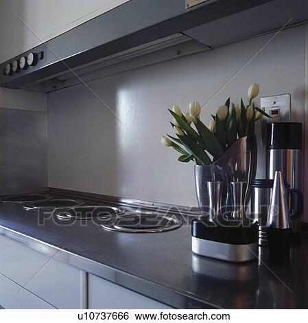 Close-up of three burners set into stainless worktop in modern grey kitchen View Large Photo Image Stock Photograph - Close-up of three burners set into stainless worktop in modern grey kitchen. Fotosearch