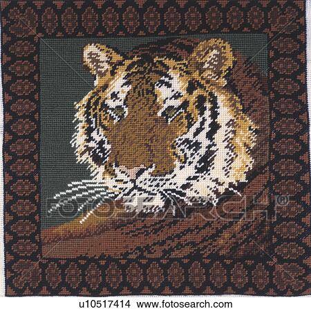 Picture - Close-up of tiger motif cross-stitch cushion. Fotosearch