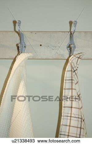 Close-up of towels hanging from metal hooks on board View Large Photo Image Stock Image - Close-up of towels hanging from metal hooks on board. Fotosearch