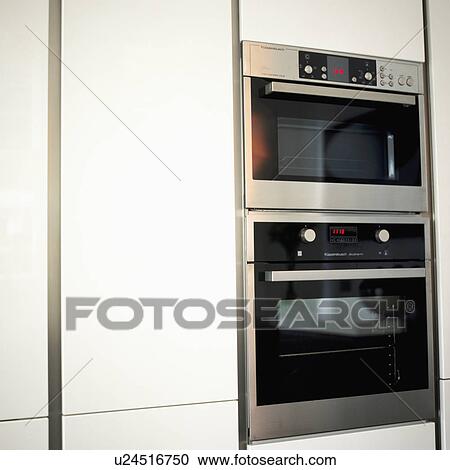 Stock Image - Close up of wall mounted stainless steel double oven. Fotosearch