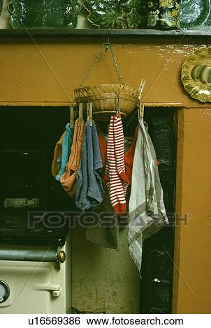 Close-up of washing pegged to basket suspended from fireplace View Large Photo Image Stock Photograph - Close-up of washing pegged to basket suspended from fireplace. Fotosearch