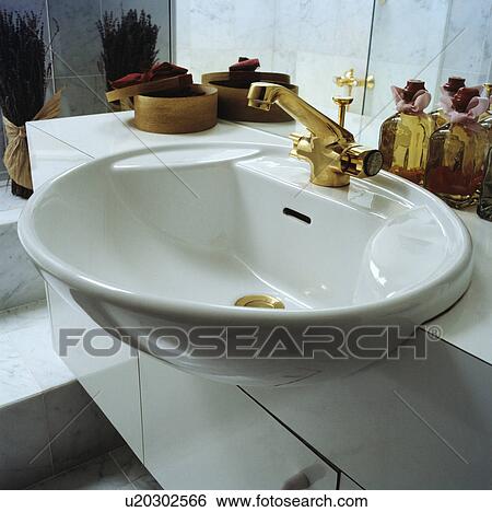 Close-up of white bathroom basin with gold tap View Large Photo Image Stock Photograph - Close-up of white bathroom basin with gold tap. Fotosearch