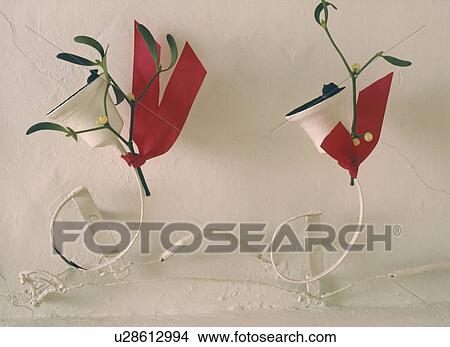 Close up of white bells tied with red ribbon on white wall View Large Photo Image Picture - Close up of white bells tied with red ribbon on white wall. Fotosearch