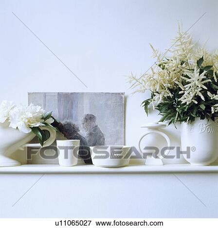 Stock Photo - Close-up of white ceramic pots and white flowers. Fotosearch