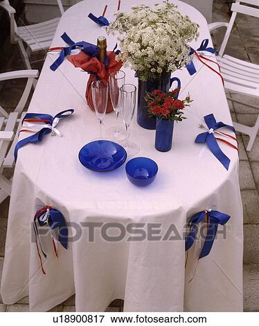 Stock Photo - Close-up of white cloth and settings on garden table. Fotosearch