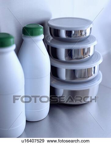 Close-up of white plastic bottles with green lids and stainless steel dishes with plastic lids View Large Photo Image Stock Photo - Close-up of white plastic bottles with green lids and stainless steel dishes with plastic lids. Fotosearch