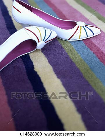 Close-up of white shoes on colourful striped rug View Large Photo Image Stock Image - Close-up of white shoes on colourful striped rug. Fotosearch