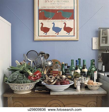 Close-up of wine bottles and bowls of fresh vegetables on cupboard View Large Photo Image Stock Photograph - Close-up of wine bottles and bowls of fresh vegetables on cupboard. Fotosearch
