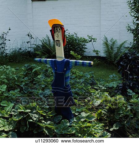 Stock Image - Close-up of wooden scarecrow. Fotosearch