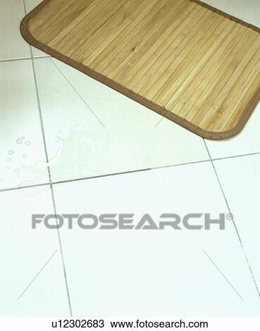 Stock Image - Closeup of large white ceramic tiles used in bathroom. Fotosearch