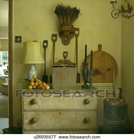 Collection of old miniature spades above chest of drawers with paint effect marbling in neutral hall View Large Photo Image Stock Photo - Collection of old miniature spades above chest of drawers with paint effect marbling in neutral hall. Fotosearch