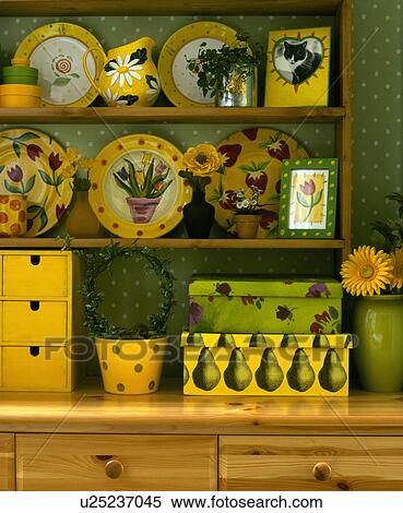 Collection of patterned yellow plates and jug on shelves above green and yellow storage boxes View Large Photo Image Stock Photography - Collection of patterned yellow plates and jug on shelves above green and yellow storage boxes. Fotosearch