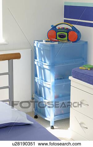 Colourful radio on blue plastic storage boxes in child's bedroom View Large Photo Image Stock Image - Colourful radio on blue plastic storage boxes in child's bedroom. Fotosearch