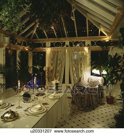 Conservatory dining at night with candles and lace curtains View Large Photo Image Stock Photo - Conservatory dining at night with candles and lace curtains. Fotosearch