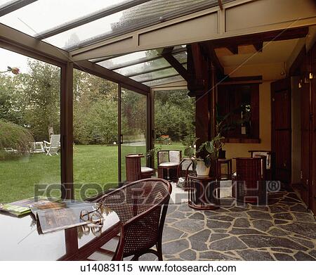 Conservatory dining room with crazy-paving floor and view of garden through windows View Large Photo Image Stock Photography - Conservatory dining room with crazy-paving floor and view of garden through windows. Fotosearch