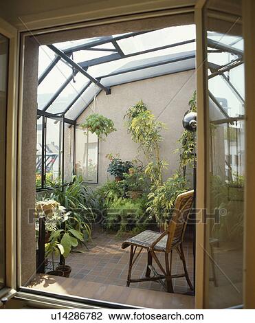 Stock Image - conservatory, interior, town, houseplant, doorway, extension. Fotosearch