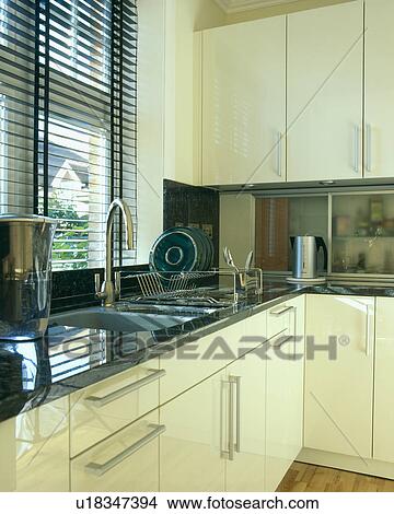 Contemporary black and white kitchen with venetion blind. View Large Photo Image Picture - Contemporary black and white kitchen with venetion blind.. Fotosearch