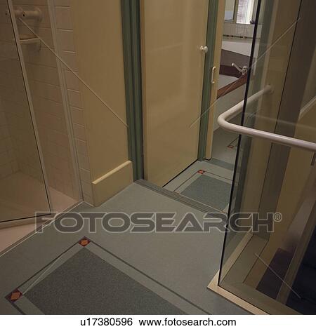 Stock Photograph - Contrasting grey flooring in modern bathroom. Fotosearch