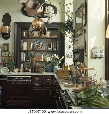 copper pans on ceiling rack in traditional kitchen with dark wood fitted cupboards View Large Photo Image Stock Image - copper pans on ceiling rack in traditional kitchen with dark wood fitted cupboards. Fotosearch