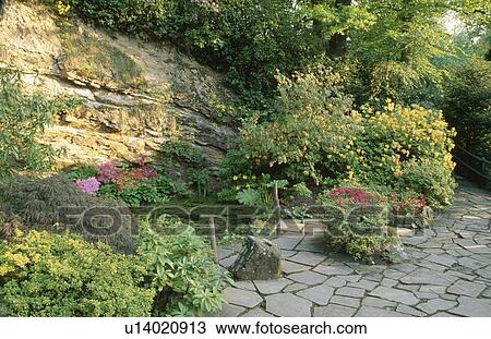 Crazy paving and pond in garden with rock wall  View Large Photo Image Stock Image - Crazy paving and pond in garden with rock wall . Fotosearch