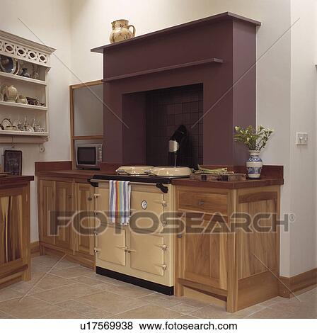 Cream aga below brown fireplace in wooden fitted kitchen View Large Photo Image Stock Photo - Cream aga below brown fireplace in wooden fitted kitchen. Fotosearch