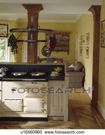 Cream Aga in island unit in traditional kitchen with sofas in background View Large Photo Image Stock Image - Cream Aga in island unit in traditional kitchen with sofas in background. Fotosearch