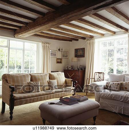Cream Checked Sofa In Traditional Cottage Living Room Stock Photo