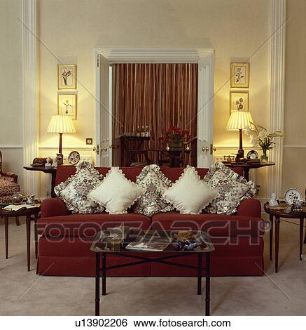 Stock Images Of Cream Cushions On Red Sofa In Traditional Living Cream Cushions On Red Sofa In Traditional Living Room