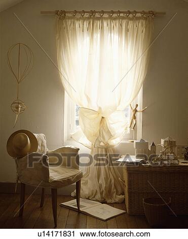 Cream loosecover on chair in front of window with cream voile curtain View Large Photo Image Stock Image - Cream loosecover on chair in front of window with cream voile curtain. Fotosearch