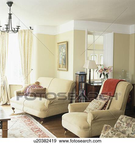 Stock Photo - Cream sofa and armchair in neutral livingroom. Fotosearch