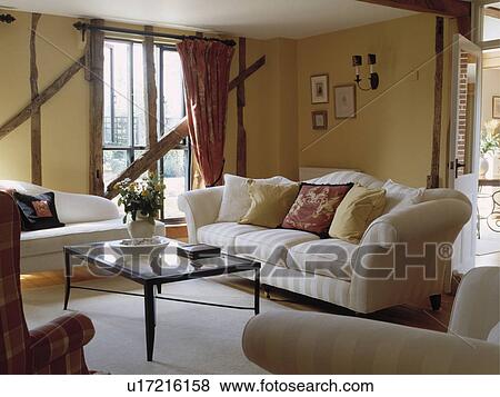 Cream sofa in traditional cottage living room View Large Photo Image Stock Photo - Cream sofa in traditional cottage living room. Fotosearch
