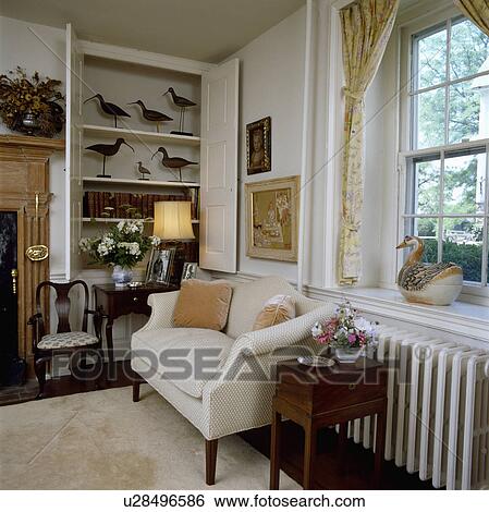 Stock Photograph - Cream sofa in traditional living room. Fotosearch