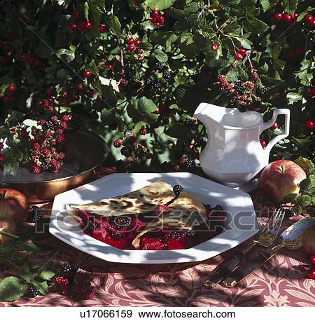 Stock Photo - Crepe filled with backberries - cream in jug.. Fotosearch