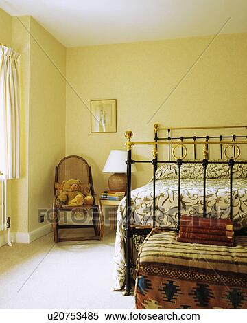 Crewelwork bedspread on antique brass bed in country bedroom with Bentwood rocking chair View Large Photo Image Stock Photography - Crewelwork bedspread on antique brass bed in country bedroom with Bentwood rocking chair. Fotosearch