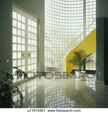Curved glass brick wall and yellow staircase in modern hall with polished pale grey flooring and double glazed doors View Large Photo Image Stock Image - Curved glass brick wall and yellow staircase in modern hall with polished pale grey flooring and double glazed doors. Fotosearch