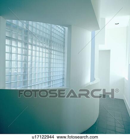 Picture - Curved wall in front of glass bricks in corridor in modern architectural hall. Fotosearch