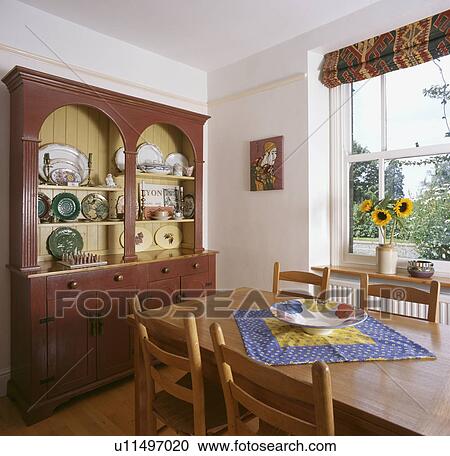 Dark wood dresser in dining room with pale wood furniture View Large Photo Image Stock Image - Dark wood dresser in dining room with pale wood furniture. Fotosearch