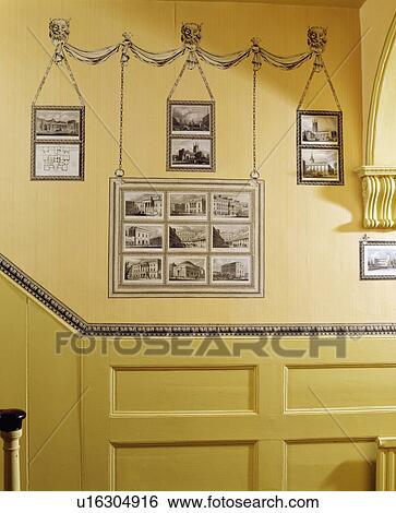 Decoupage black+white prints on cream wall above dado panelling in traditional hall View Large Photo Image Stock Photograph - Decoupage black+white prints on cream wall above dado panelling in traditional hall. Fotosearch