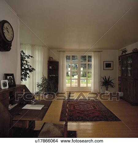 Desk in corner of livingroom provides sufficient space to keep household accounts. View Large Photo Image Picture - Desk in corner of livingroom provides sufficient space to keep household accounts.. Fotosearch