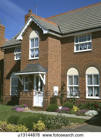 Detached brick newbuild house with small front garden View Large Photo Image Stock Photograph - Detached brick newbuild house with small front garden. Fotosearch