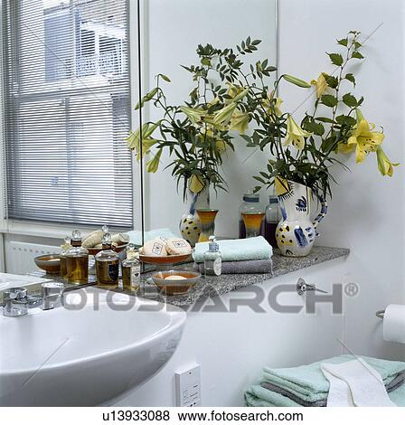 Stock Photo - Detail of the corner of white painted modern bathroom with marble shelf and venetian blind. Fotosearch